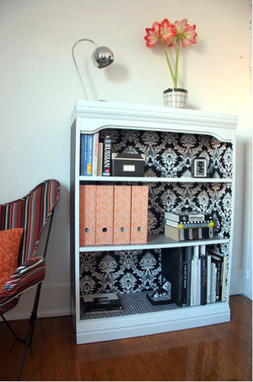 Wallpaper backed bookcase from Apartment Therapy