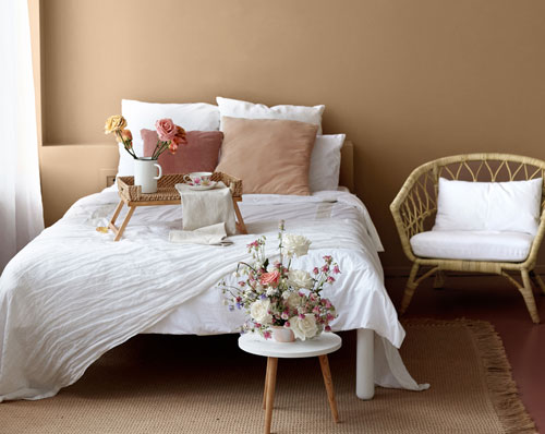 Earthy neutral bedroom with white bedding